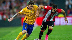 BILBAO, SPAIN - AUGUST 14:  Lionel Messi of FC Barcelona (L) duels for the ball with Mikel Balenziaga of Athletic Club during the Super Cup first leg match between of Athletic Club and FC Barcelona at San Mames Stadium on August 14, 2015 in Bilbao, Spain.  (Photo by Juan Manuel Serrano Arce/Getty Images)