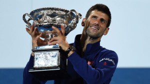 Novak Djokovic of Serbia holds up the winner's trophy at the awards ceremony following his victory over Andy Murray of Britain in their men's singles final match on day 14 of the 2016 Australian Open tennis tournament in Melbourne on January 31, 2016.     AFP PHOTO / GREG WOOD -- IMAGE RESTRICTED TO EDITORIAL USE - STRICTLY NO COMMERCIAL USE