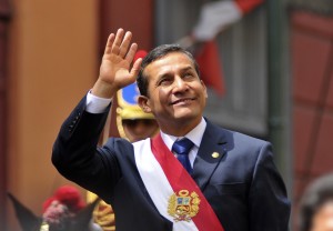 Peru's President Ollanta Humala waves from the back of a vehicle as he rides from Congress to the presidential palace in Lima